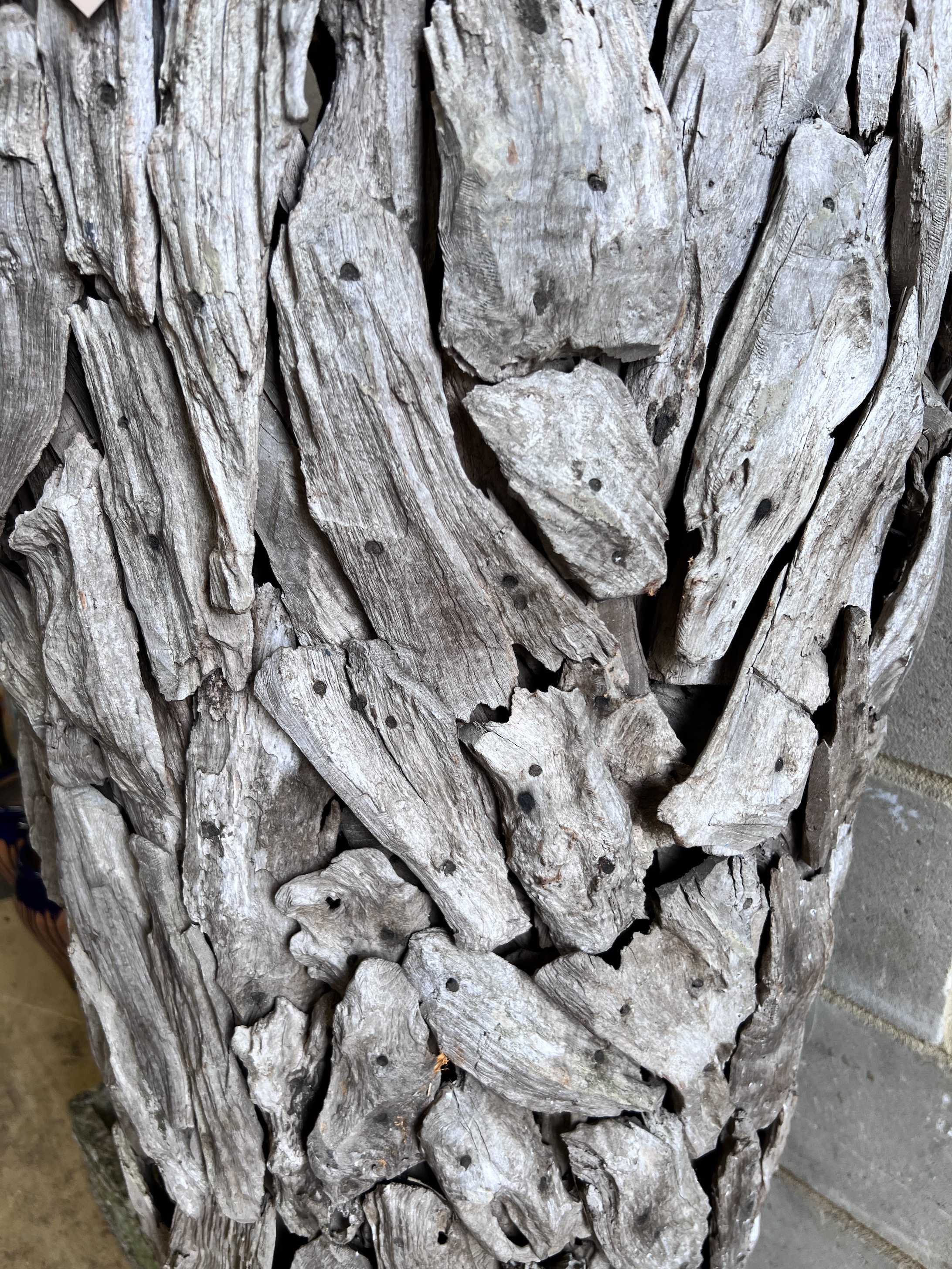 A large driftwood urn shaped garden ornament, height 155cm